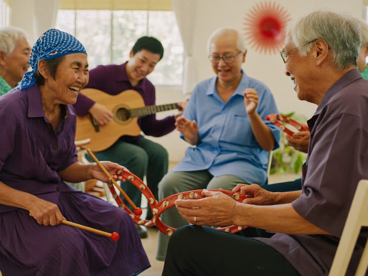 Seniors at MS Care singing and playing percussion instruments in a group music therapy circle during the CONNECT hour.